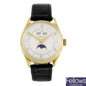 GÜBELIN - a gentleman's yellow metal triple date wrist watch.
