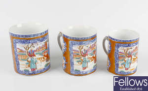 A graduated set of three Chinese Canton famille rose mugs. 