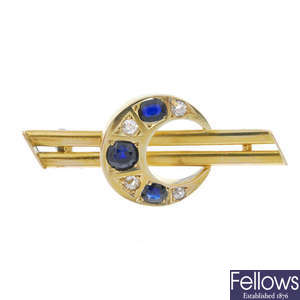 A sapphire and diamond crescent brooch. 