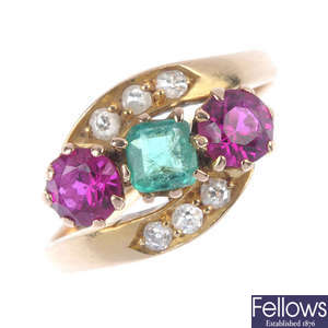 An emerald, diamond and synthetic ruby crossover ring.