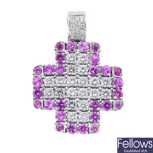 A diamond and sapphire articulated cross pendant.