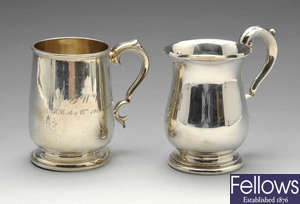Two 20th century silver mugs.
