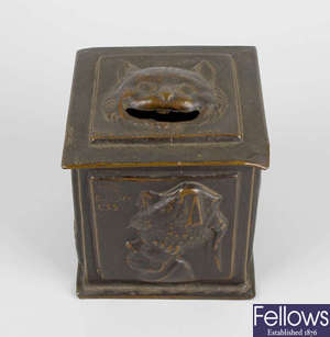 A rare Alice in Wonderland patinated brass money box