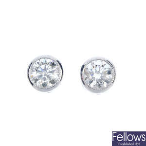 A pair of brilliant-cut diamond single-stone ear studs. 