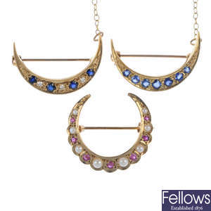 A selection of three 9ct gold gem-set crescent brooches.