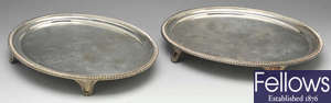 A pair of George III silver oval salvers.