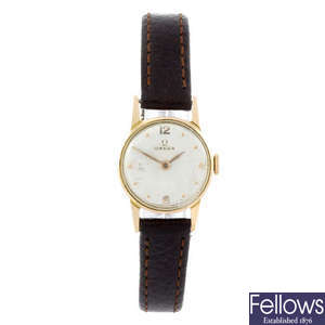 OMEGA - a lady's yellow metal wrist watch.