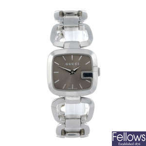 GUCCI - a lady's stainless steel bracelet watch together with another lady's bracelet watch.