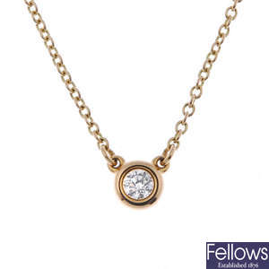  TIFFANY & CO. - an 18ct gold 'Diamonds by the Yard' single-stone pendant, by Elsa Peretti 