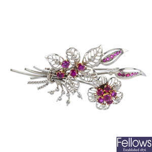 A diamond and ruby floral brooch.
