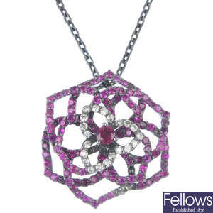 A ruby and diamond floral pendant.