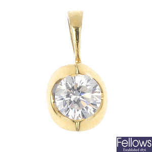 A diamond single-stone pendant and single diamond ear stud.