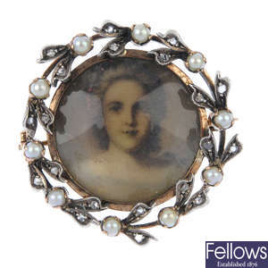 An early 20th century gold diamond and seed pearl wreath portrait brooch.