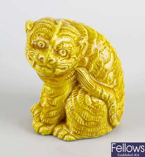 An unusual yellow-glazed figure of a seated tiger. 
