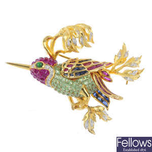 A diamond and gem-set hummingbird brooch. 