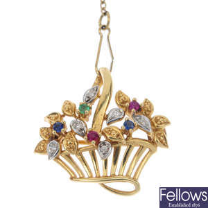 A diamond and gem-set foliate brooch.