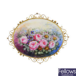 An early 20th century 9ct gold mounted ceramic floral brooch