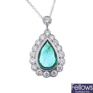 An emerald and diamond pendant.