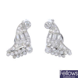 A pair of diamond ear clips.