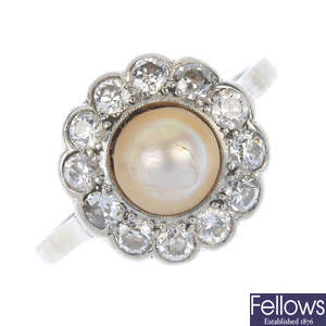 An early 20th century platinum cultured pearl and diamond ring.
