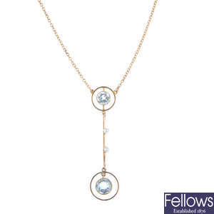 An early 20th century 9ct gold aquamarine and seed pearl pendant, on chain.