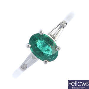 An emerald and diamond single-stone ring. 