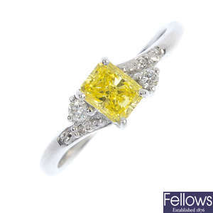 An 18ct gold colour treated 'yellow' diamond and diamond dress ring. 