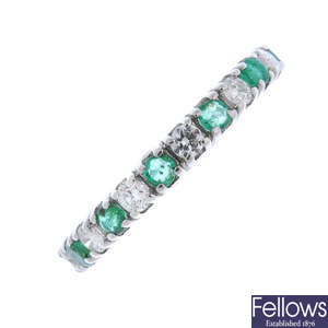 An 18ct gold emerald and diamond full-circle eternity ring.