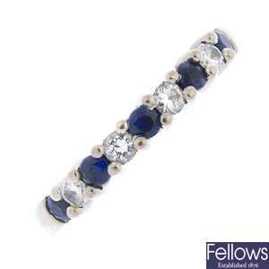 An 18ct gold sapphire and diamond half-circle eternity ring. 