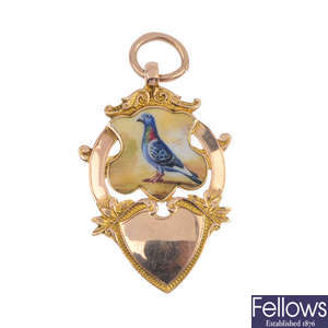 An early 20th century 9ct gold enamel pigeon medal.