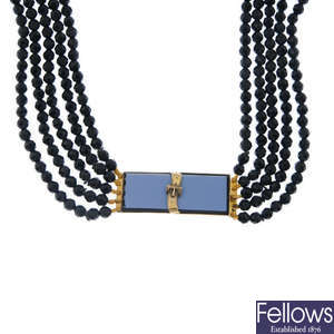 A faceted black glass multi-row necklace with late 19th century gold onyx clasp.