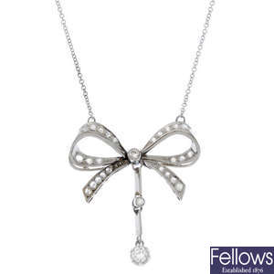 A diamond bow pendant.
