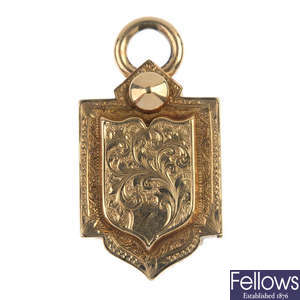A late 19th century 9ct gold cased shield-shape locket.