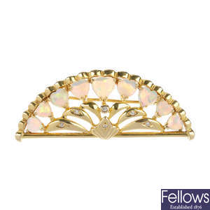 An opal and diamond fan brooch.