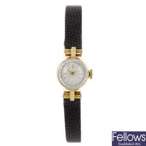 ROLEX - a lady's yellow metal wrist watch.