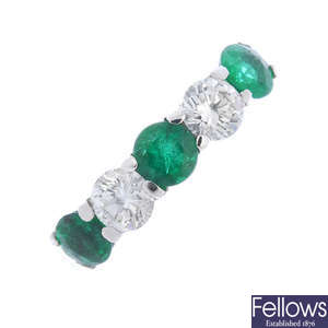 An emerald and diamond five-stone ring. 