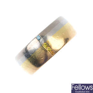 A platinum and 18ct gold colour treated diamond and diamond band ring. 