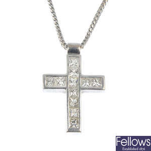 An 18ct gold diamond cross pendant, on chain.