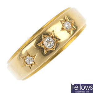 A late Victorian 18ct gold diamond three-stone band ring.