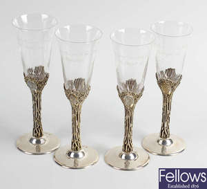 A set of four silver mounted commemorative glasses. 