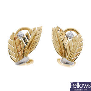 A pair of diamond foliate earrings.