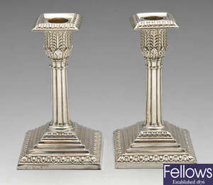 A pair of late Victorian silver Corinthian candlesticks.