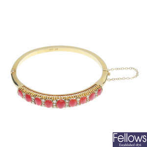 An early 20th century 15ct gold coral and diamond hinged bangle.