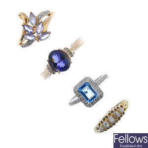 A selection of four gold diamond and gem-set rings.