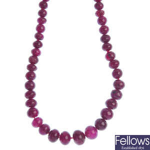 A graduated ruby bead necklace with diamond clasp.