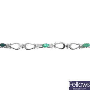 An emerald and diamond bracelet.