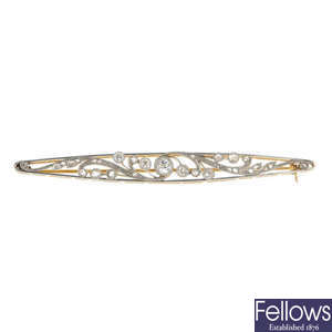 A composite early 20th century platinum and gold diamond bar brooch.