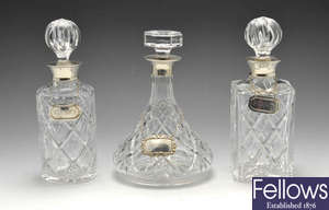 Three modern silver mounted decanters, coasters & labels.