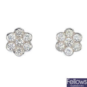 A pair of diamond cluster floral earrings.