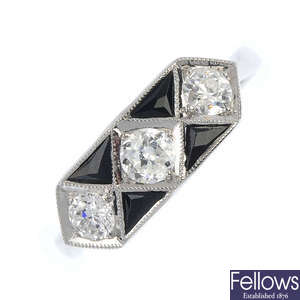 An onyx and diamond dress ring.